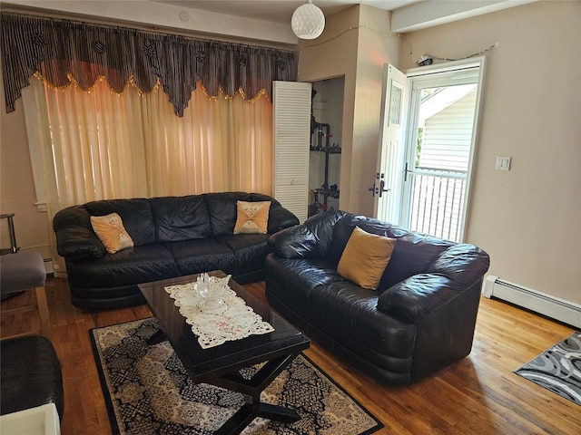 1430 Gipson St, Far Rockaway, NY 11691 - living room featuring a baseboard heating unit and wood finished floors