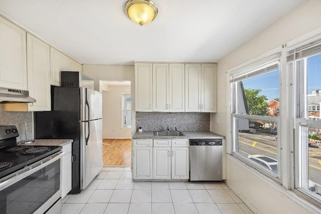 214-04 18th Ave, Bayside, NY 11360 - kitchen featuring stainless steel appliances, under cabinet range hood, tasteful backsplash, light tile patterned flooring, and light countertops