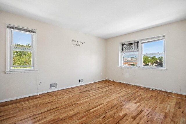 214-04 18th Ave, Bayside, NY 11360 - unfurnished room featuring light wood-type flooring and a wall mounted AC
