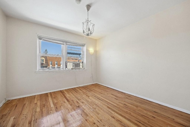 214-04 18th Ave, Bayside, NY 11360 - unfurnished room featuring a chandelier and wood finished floors