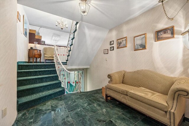 214-04 18th Ave, Bayside, NY 11360 - staircase featuring a chandelier