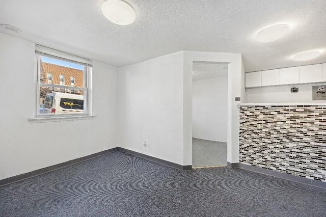 214-04 18th Ave, Bayside, NY 11360 - spare room with a textured ceiling and carpet floors