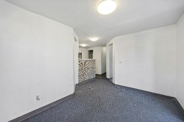 214-04 18th Ave, Bayside, NY 11360 - carpeted spare room with baseboards and a textured ceiling