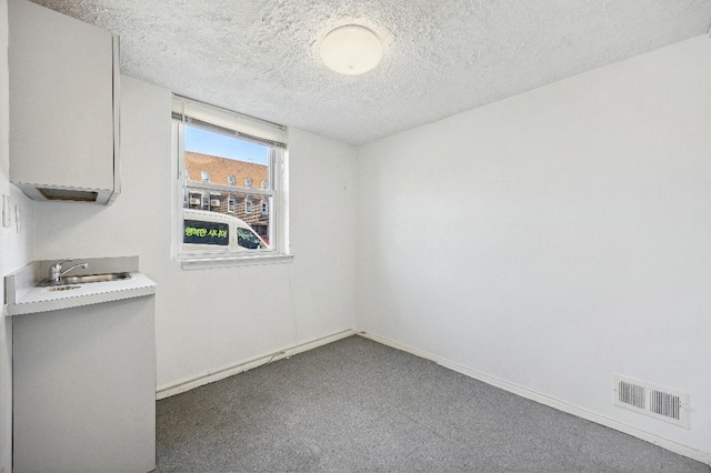 214-04 18th Ave, Bayside, NY 11360 - unfurnished dining area featuring a textured ceiling and carpet floors