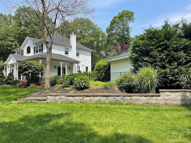 2 William St, East Setauket, NY 11733 - view of front of property featuring a chimney, a shingled roof, and a front yard