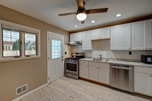 21 Clifford Blvd, Hauppauge, NY 11788 - kitchen featuring appliances with stainless steel finishes, under cabinet range hood, light countertops, tasteful backsplash, and ceiling fan