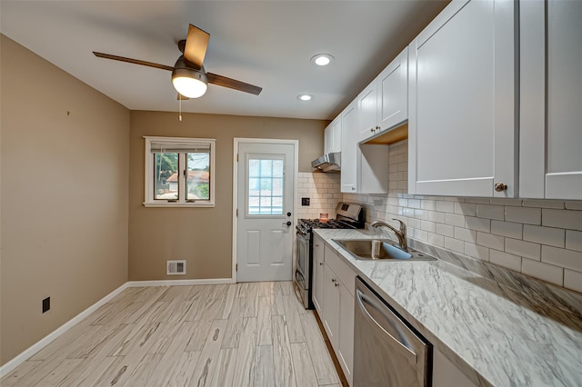 21 Clifford Blvd, Hauppauge, NY 11788 - kitchen with appliances with stainless steel finishes, backsplash, a ceiling fan, exhaust hood, and white cabinetry