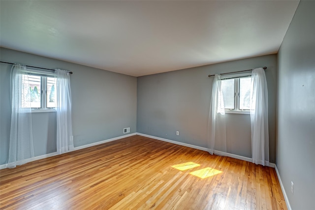21 Clifford Blvd, Hauppauge, NY 11788 - unfurnished room with healthy amount of natural light and hardwood / wood-style floors