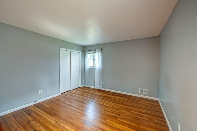 21 Clifford Blvd, Hauppauge, NY 11788 - unfurnished bedroom with wood finished floors and a closet