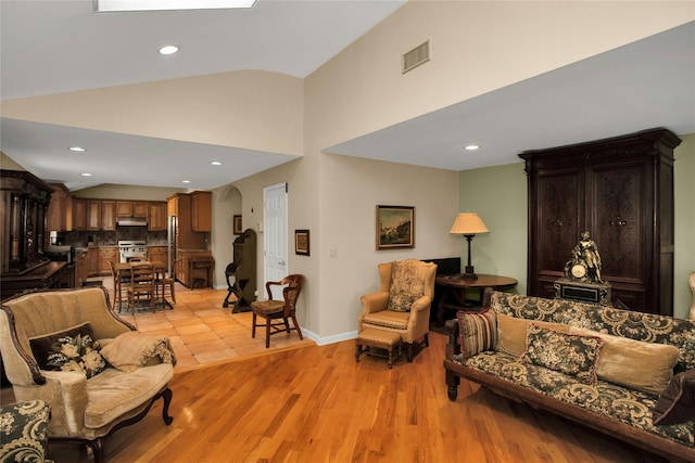 15 Howard Ct, Plainview, NY 11803 - living area featuring arched walkways, light wood-style flooring, recessed lighting, and high vaulted ceiling