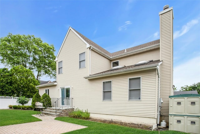 15 Howard Ct, Plainview, NY 11803 - back of property featuring a patio area and a chimney