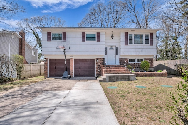 756 Bohemia Pkwy, Sayville, NY 11782 - bi-level home with concrete driveway, brick siding, and an attached garage