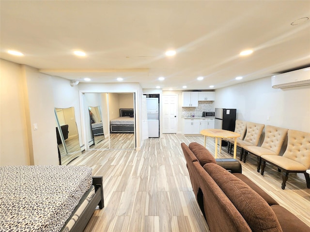 756 Bohemia Pkwy, Sayville, NY 11782 - living area featuring a wall unit AC, recessed lighting, and light wood-style floors