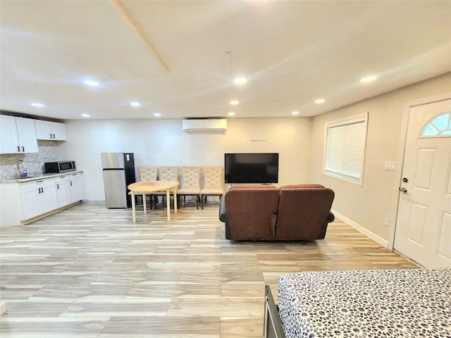 756 Bohemia Pkwy, Sayville, NY 11782 - living area with a wall mounted AC, recessed lighting, and light wood-type flooring