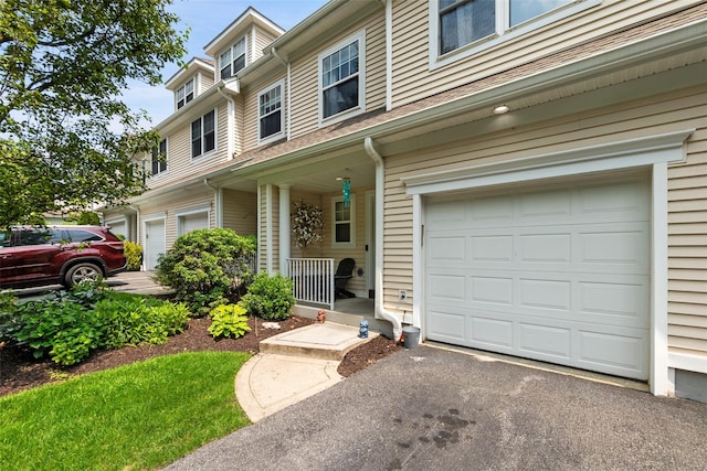 97 Hillcrest Ln, Peekskill, NY 10566 - townhome / multi-family property featuring an attached garage, a porch, and driveway