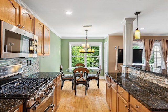 97 Hillcrest Ln, Peekskill, NY 10566 - kitchen featuring appliances with stainless steel finishes, light wood-type flooring, tasteful backsplash, pendant lighting, and crown molding