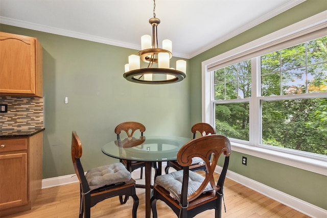 97 Hillcrest Ln, Peekskill, NY 10566 - dining room featuring healthy amount of natural light, a chandelier, light wood-style flooring, and ornamental molding