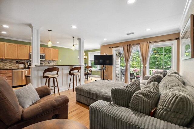 97 Hillcrest Ln, Peekskill, NY 10566 - living area with decorative columns, ornamental molding, healthy amount of natural light, recessed lighting, and light wood finished floors