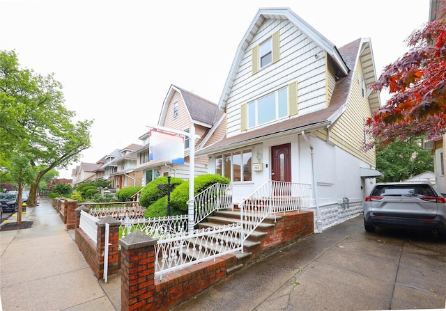 1768 W 5th St, Brooklyn, NY 11223 - view of front facade with roof with shingles and a gambrel roof