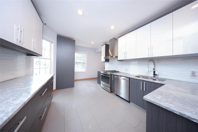 1768 W 5th St, Brooklyn, NY 11223 - kitchen featuring appliances with stainless steel finishes, wall chimney exhaust hood, decorative backsplash, light stone countertops, and recessed lighting