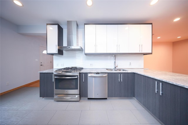 1768 W 5th St, Brooklyn, NY 11223 - kitchen with wall chimney exhaust hood, appliances with stainless steel finishes, white cabinets, backsplash, and recessed lighting
