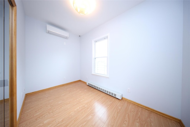 1768 W 5th St, Brooklyn, NY 11223 - spare room with a wall unit AC, light wood-style floors, and a baseboard radiator