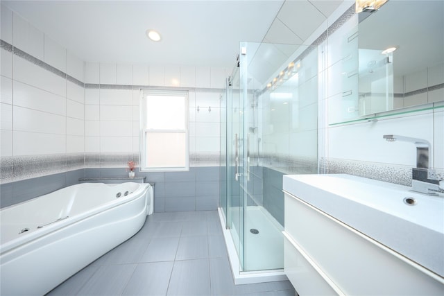 1768 W 5th St, Brooklyn, NY 11223 - full bathroom featuring tile walls, tile patterned flooring, a shower stall, vanity, and a garden tub