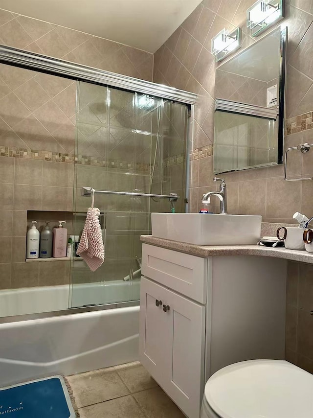 134-54 Maple Ave Unit 3V, Flushing, NY 11355 - full bath featuring tile walls, vanity, bath / shower combo with glass door, tile patterned flooring, and tasteful backsplash