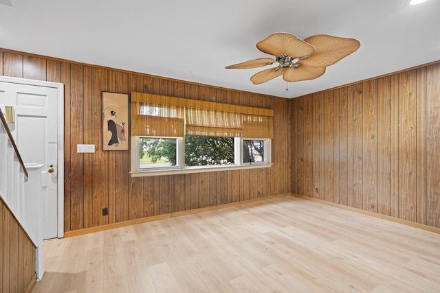 302 Waukena Ave, Oceanside, NY 11572 - unfurnished room with wood finished floors, wood walls, a ceiling fan, and stairway