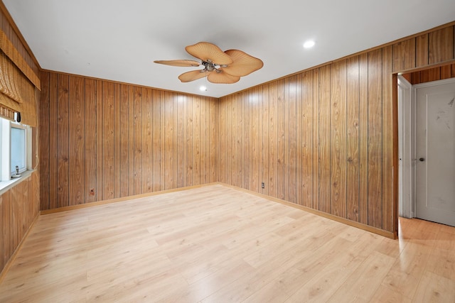 302 Waukena Ave, Oceanside, NY 11572 - empty room featuring ceiling fan, wood walls, and light wood-type flooring