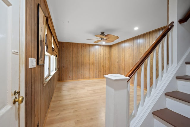 302 Waukena Ave, Oceanside, NY 11572 - entrance foyer with wood walls, ceiling fan, light wood-type flooring, and stairs