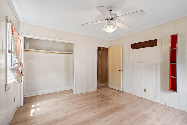 302 Waukena Ave, Oceanside, NY 11572 - unfurnished bedroom featuring wood finished floors, a closet, and a ceiling fan