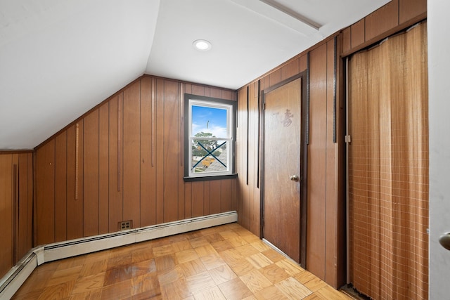 302 Waukena Ave, Oceanside, NY 11572 - additional living space featuring a baseboard heating unit, wooden walls, and lofted ceiling