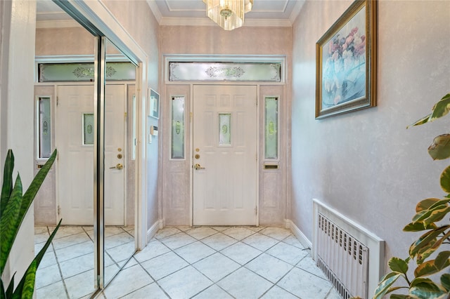 1020 New Mcneil Ave, Lawrence, NY 11559 - entrance foyer with radiator, light tile patterned flooring, crown molding, and a chandelier