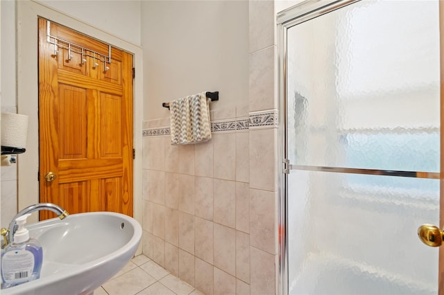 1020 New Mcneil Ave, Lawrence, NY 11559 - bathroom featuring tile walls, a shower stall, tile patterned flooring, and wainscoting