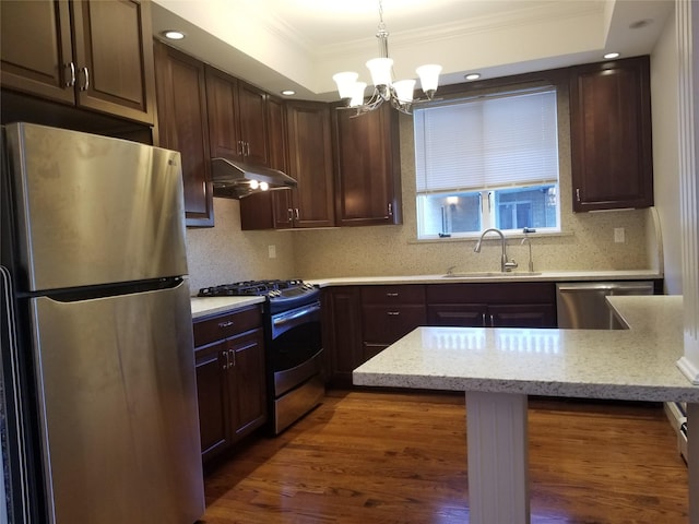 45-44 E 189th St, Flushing, NY 11368 - kitchen with stainless steel appliances, under cabinet range hood, crown molding, a chandelier, and wood finished floors