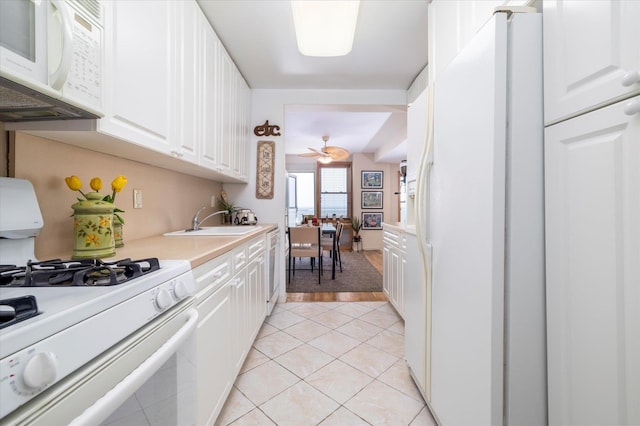 522 Shore Rd Unit 4Kk, Long Beach, NY 11561 - kitchen featuring white appliances, white cabinetry, light countertops, and light tile patterned floors