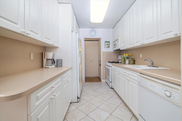 522 Shore Rd Unit 4Kk, Long Beach, NY 11561 - kitchen featuring white appliances, light tile patterned floors, light countertops, and white cabinetry