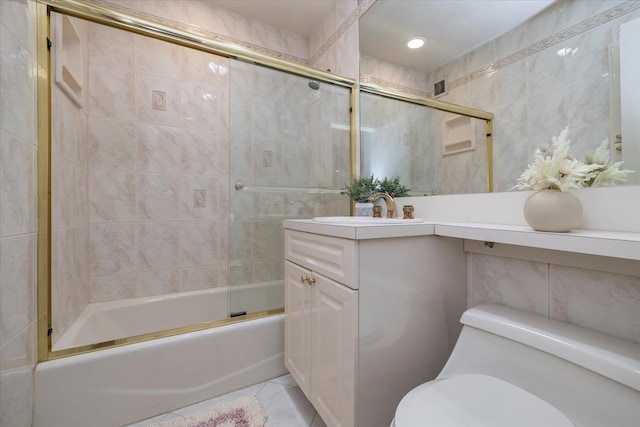 522 Shore Rd Unit 4Kk, Long Beach, NY 11561 - bathroom featuring tile walls, vanity, combined bath / shower with glass door, and tile patterned floors