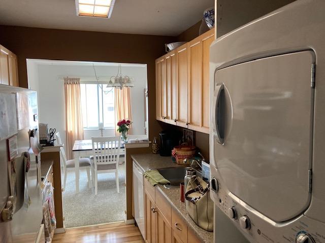 24 Village Park Dr Unit 3F, Fishkill, NY 12524 - kitchen featuring stacked washer / dryer, light countertops, dishwasher, and light wood-style floors