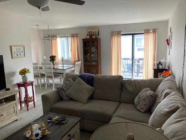 24 Village Park Dr Unit 3F, Fishkill, NY 12524 - living room with a chandelier, ceiling fan, and carpet floors
