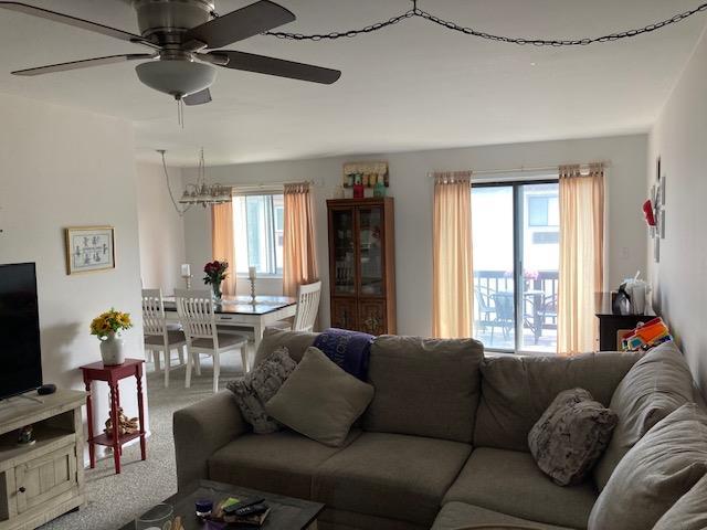 24 Village Park Dr Unit 3F, Fishkill, NY 12524 - living area featuring plenty of natural light, a ceiling fan, a chandelier, and carpet floors