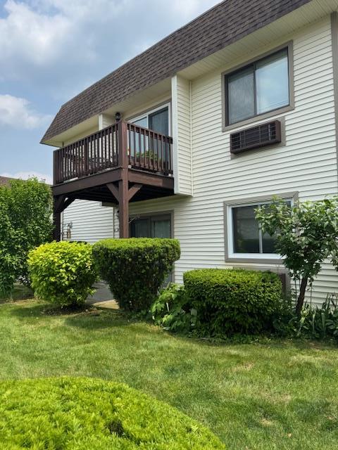 24 Village Park Dr Unit 3F, Fishkill, NY 12524 - view of property exterior featuring a balcony, roof with shingles, a yard, and mansard roof
