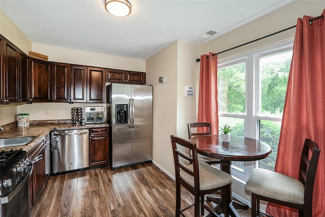15 Juniper Ct Unit 15, Selden, NY 11784 - kitchen featuring appliances with stainless steel finishes, dark wood finished floors, dark brown cabinetry, and dark countertops