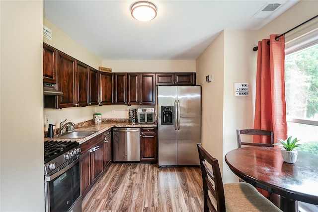 15 Juniper Ct Unit 15, Selden, NY 11784 - kitchen with stainless steel appliances, exhaust hood, light wood-style floors, and dark brown cabinets
