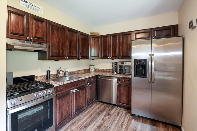 15 Juniper Ct Unit 15, Selden, NY 11784 - kitchen featuring appliances with stainless steel finishes, under cabinet range hood, light wood finished floors, and dark brown cabinetry