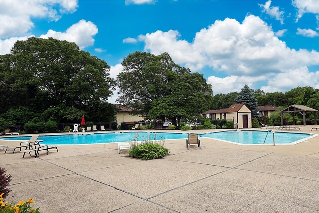 15 Juniper Ct Unit 15, Selden, NY 11784 - community pool featuring a patio, a gazebo, and view of wooded area