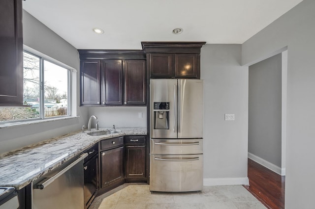 15 Bart Dr, Selden, NY 11784 - kitchen featuring appliances with stainless steel finishes, light stone counters, dark brown cabinetry, and recessed lighting