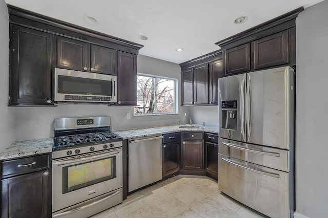 15 Bart Dr, Selden, NY 11784 - kitchen featuring stainless steel appliances, light stone countertops, dark brown cabinets, and recessed lighting