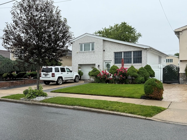159-23 90th St, Howard Beach, NY 11414 - view of front of home with a garage, a gate, concrete driveway, and a front lawn